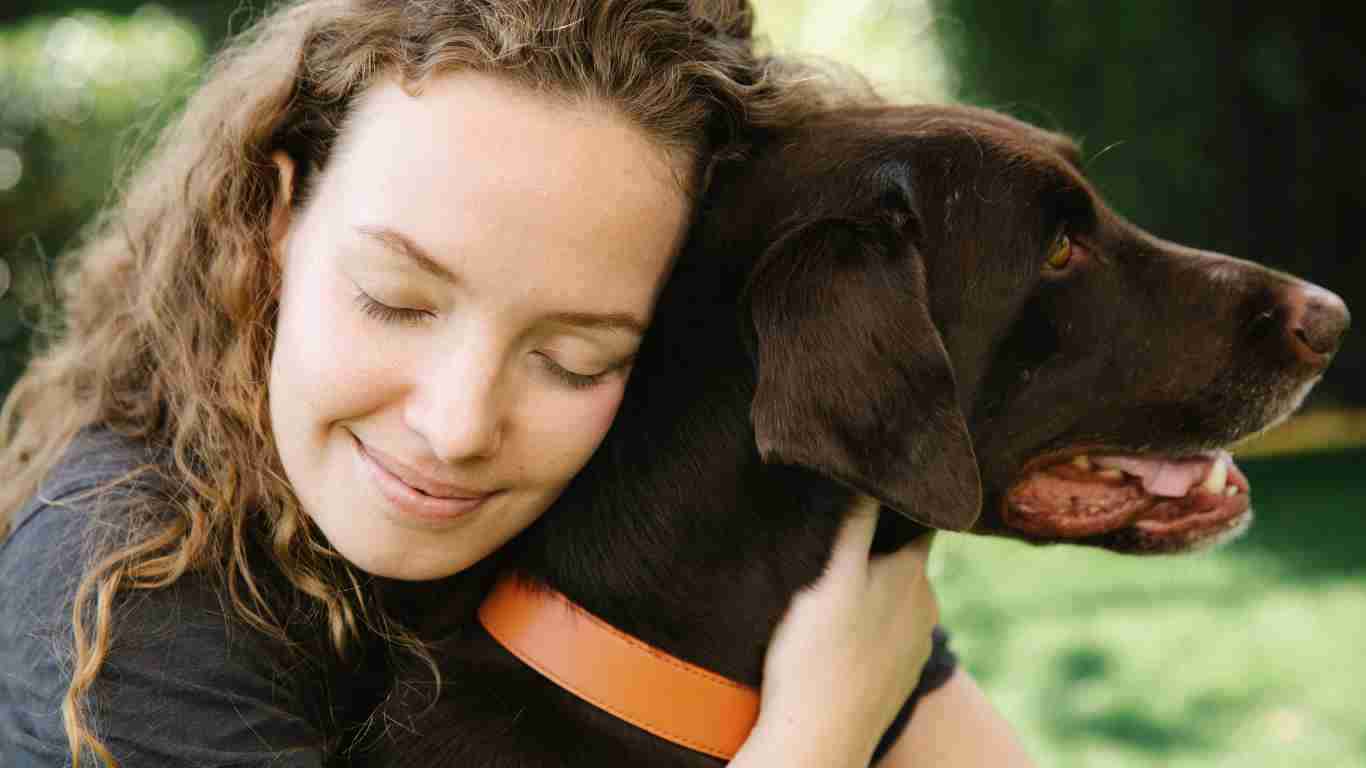 A woman hugging her dog