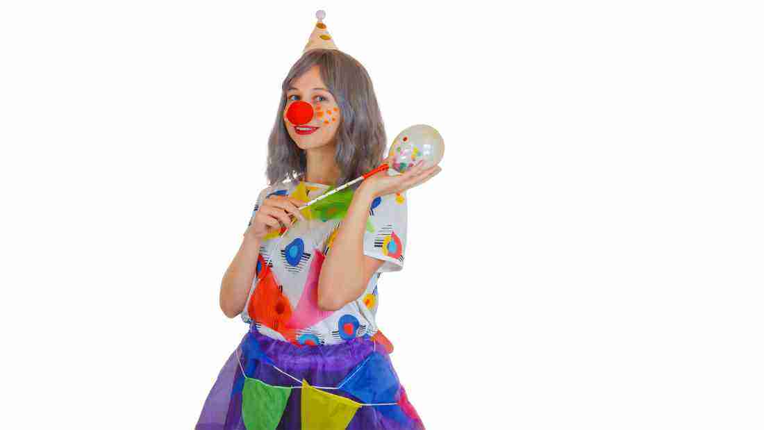 A little girl dressed as a clown
