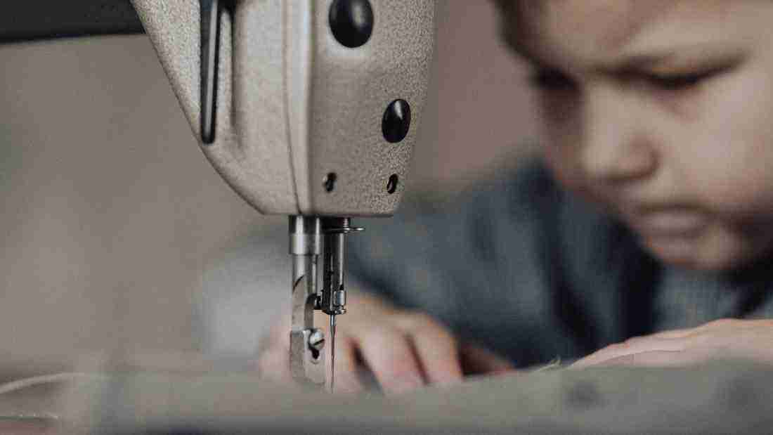 A child using a sewing machine