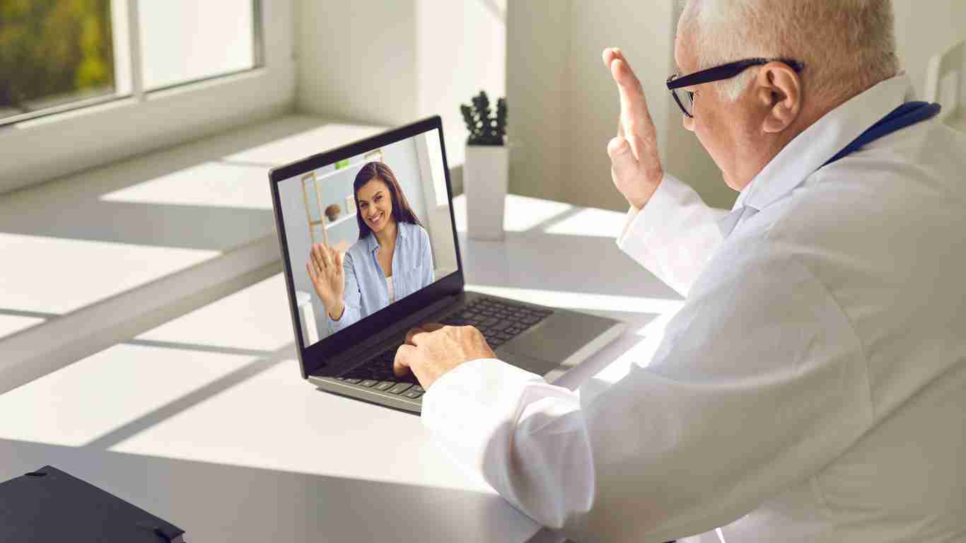 A therapist talking to her client via laptop