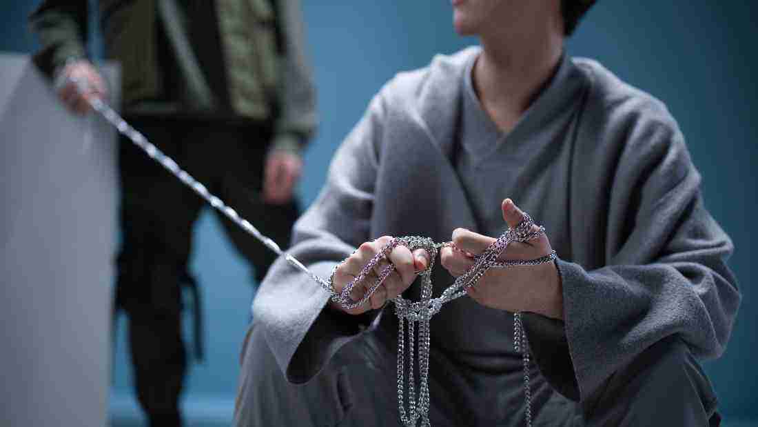 A boy who is chained up