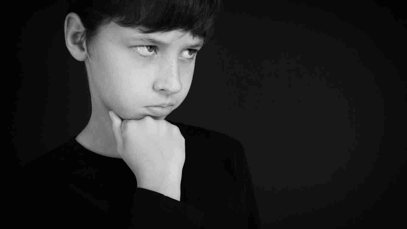 An angry little boy glaring at someone
