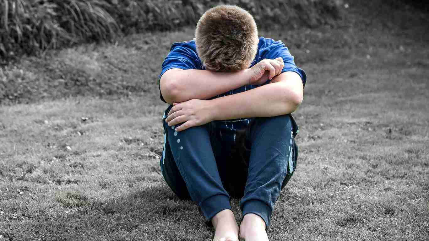 A young boy crouched on the floor