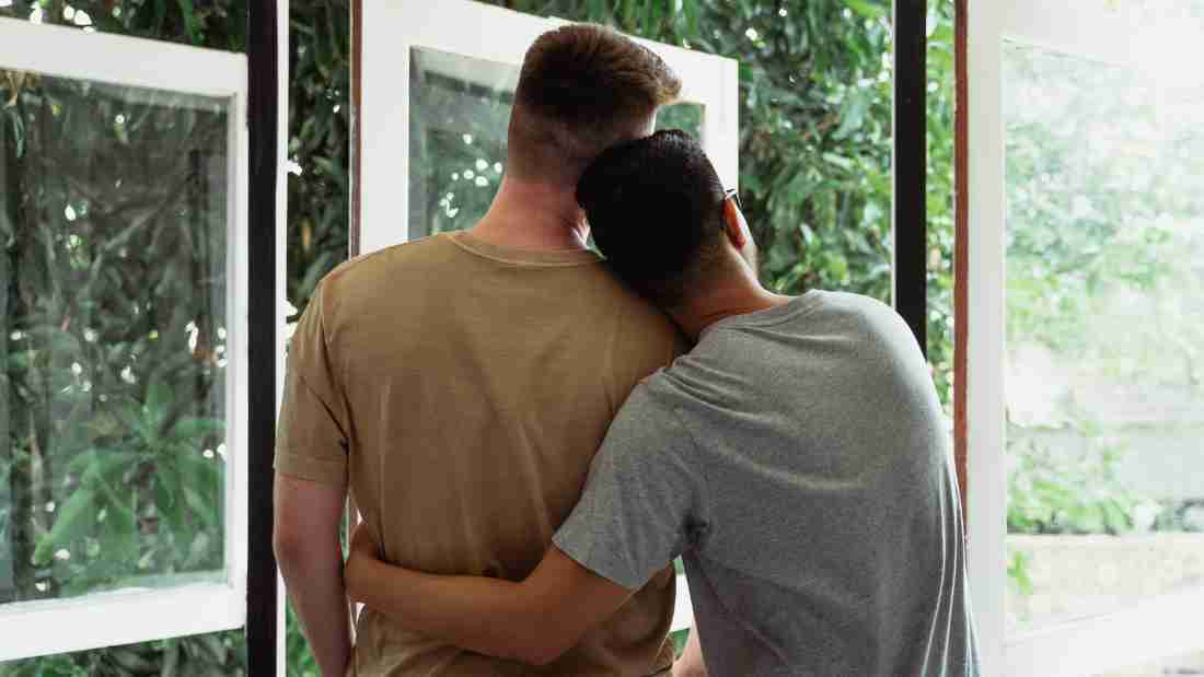 A gay couple embracing