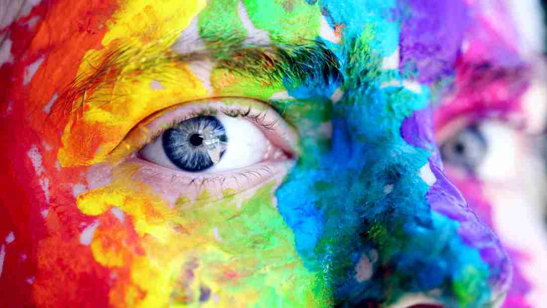 A young man covered in makeup to celebrate gay pride