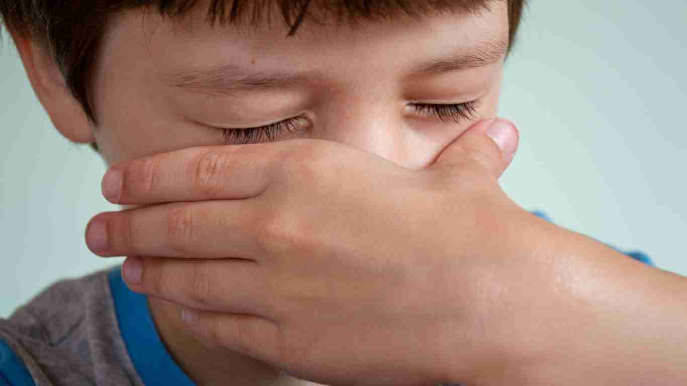 A little boy wiping away his tears