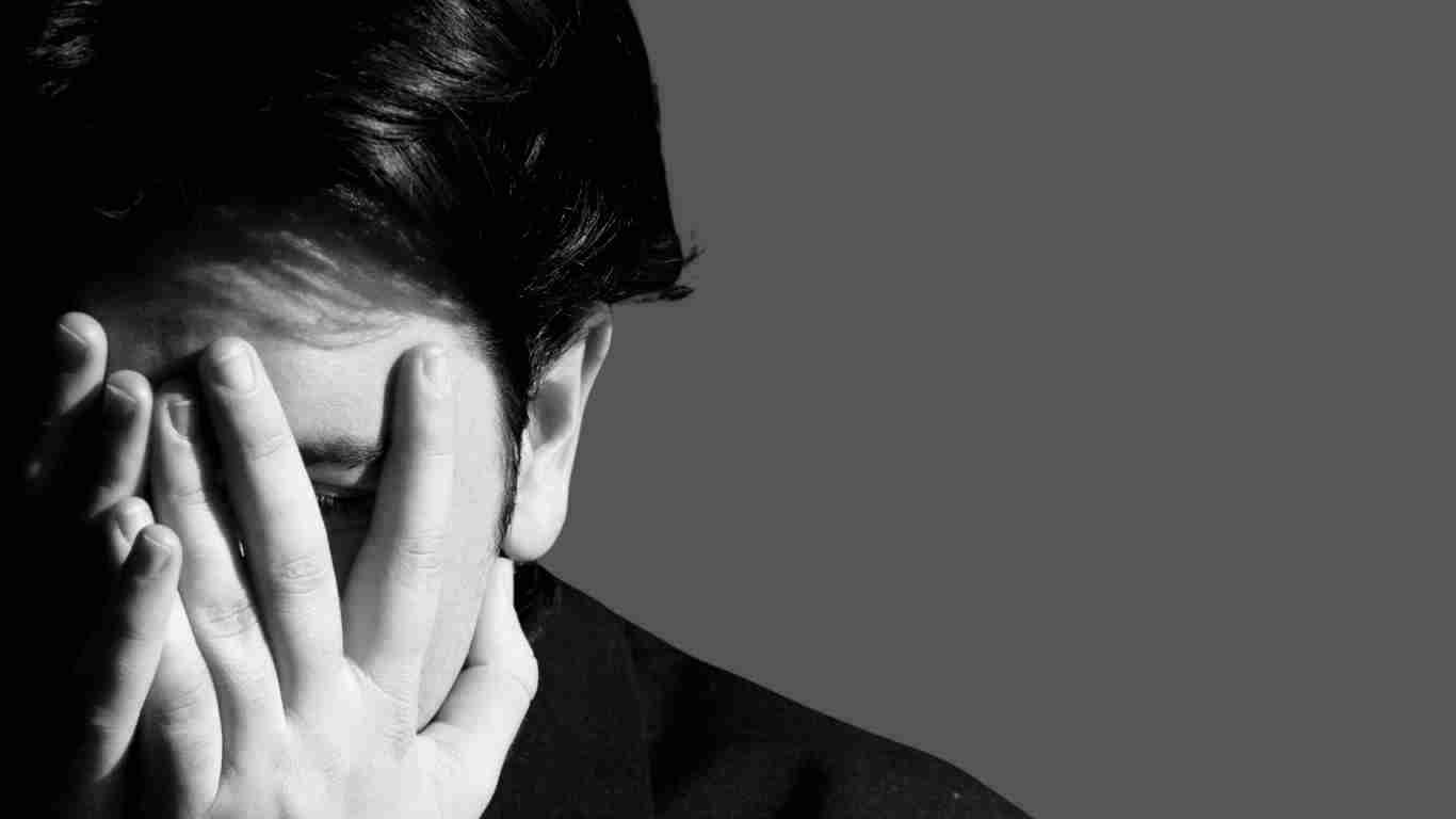 A man overwhelmed by shame