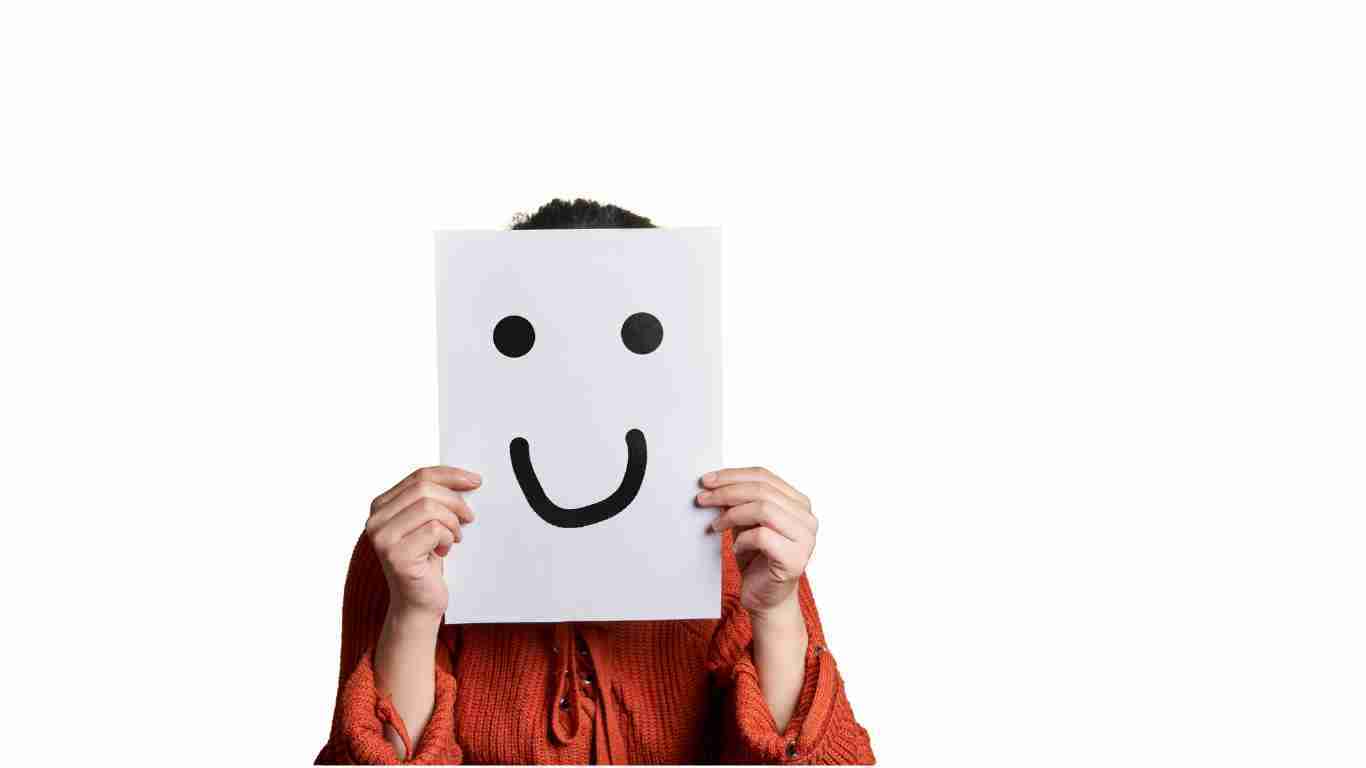A person wearing a fake smile and hiding their real feelings