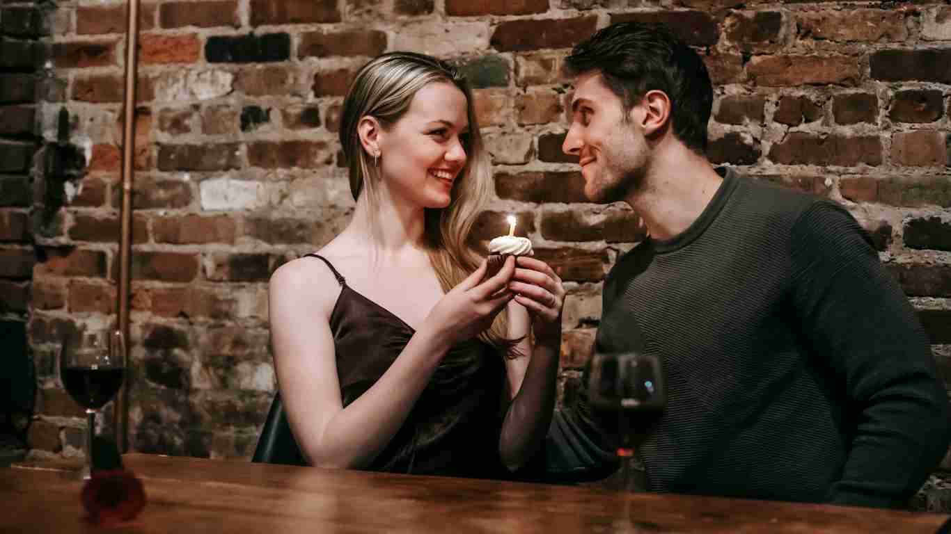 A couple drinking wine during a date in a bar