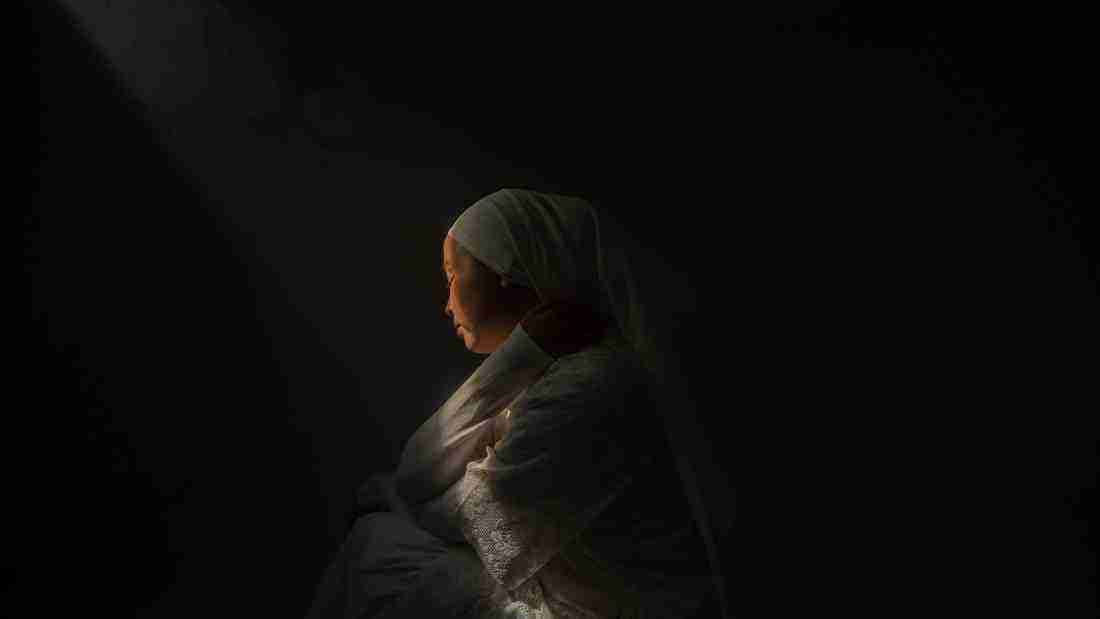 A lonely woman in a dark room