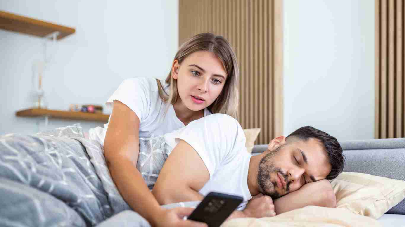 A woman spying on her partner's phone