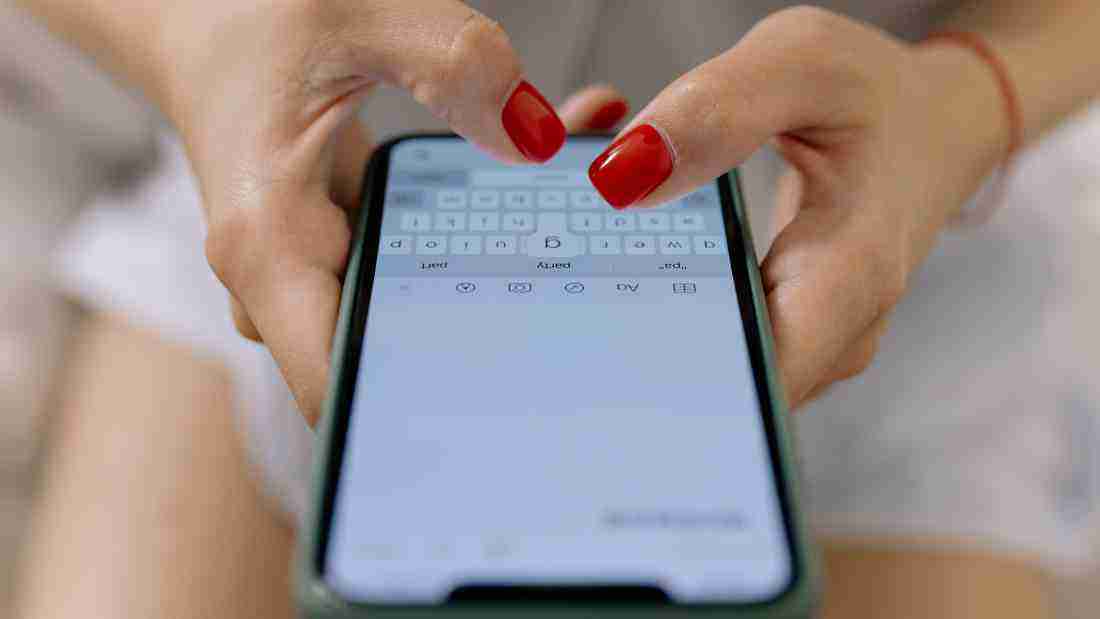 A woman typing a text on her phone
