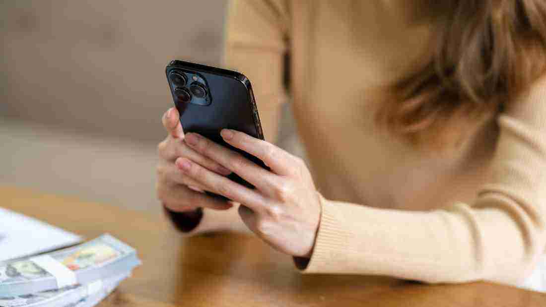 A woman reading a text message on her phone