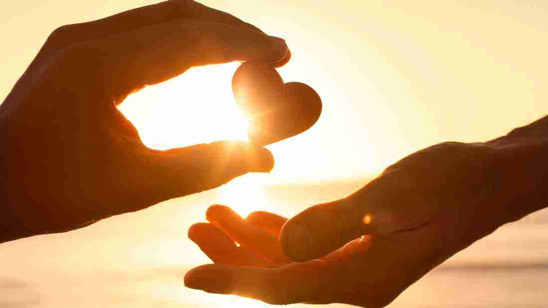 Hands giving someone a heart, symbolizing empathy and kindness