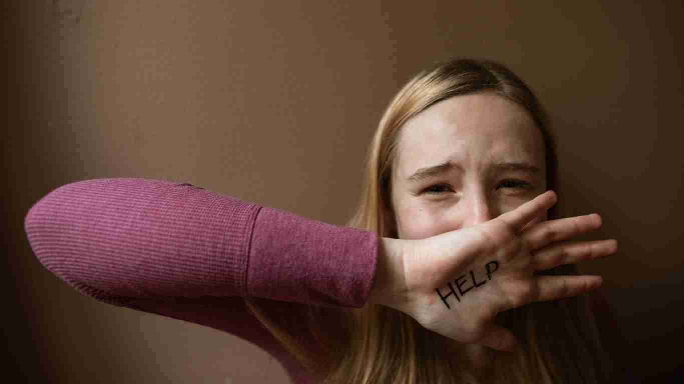 A abused woman protecting her face
