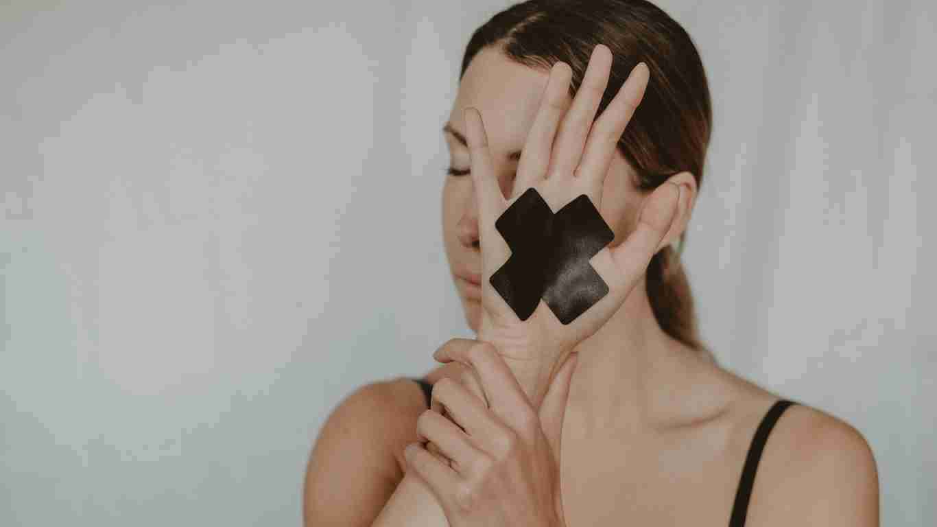An abused woman covering her face