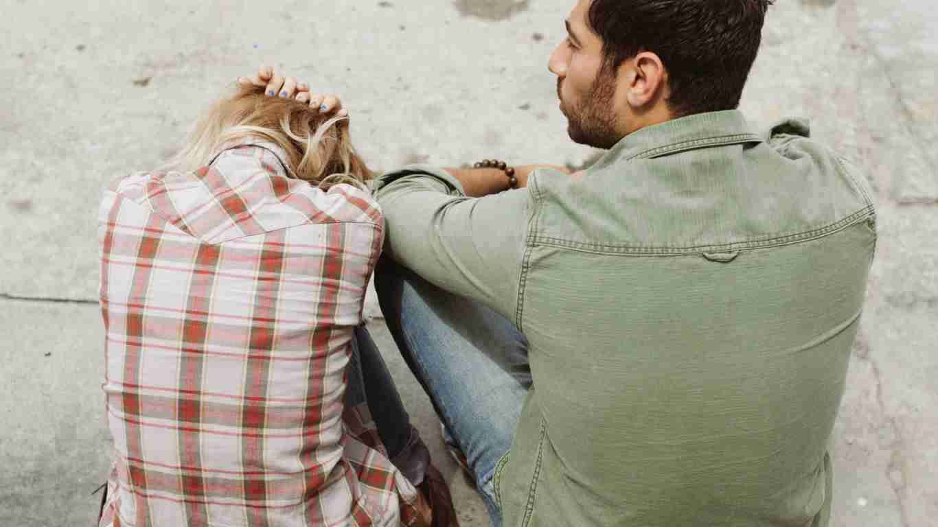 A man verbally abusing his partner, who is crying