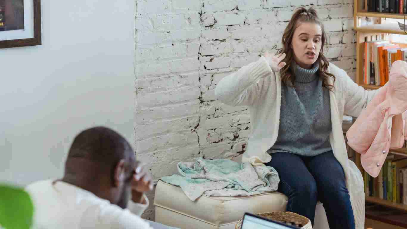 A woman screaming at her partner and blaming him for their problems