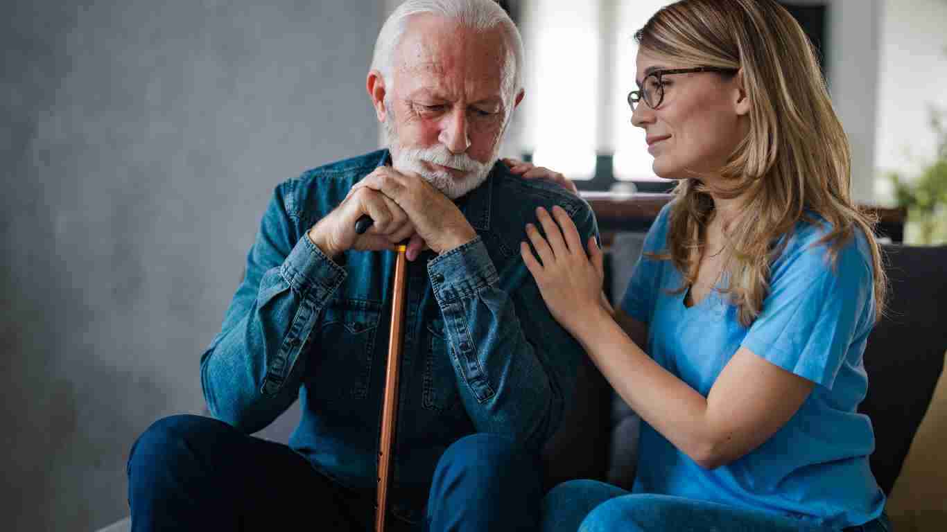 A woman helping an elderly man