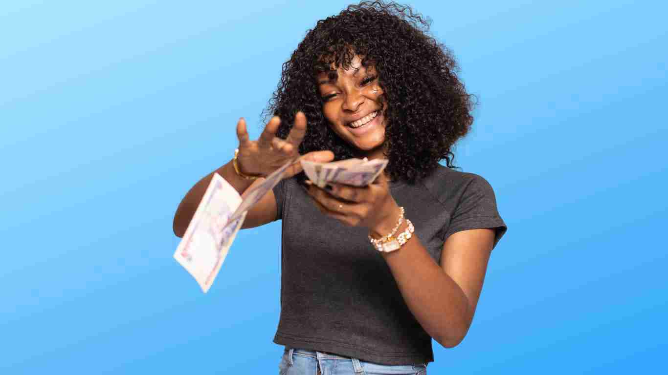A woman showing off a pile of cash