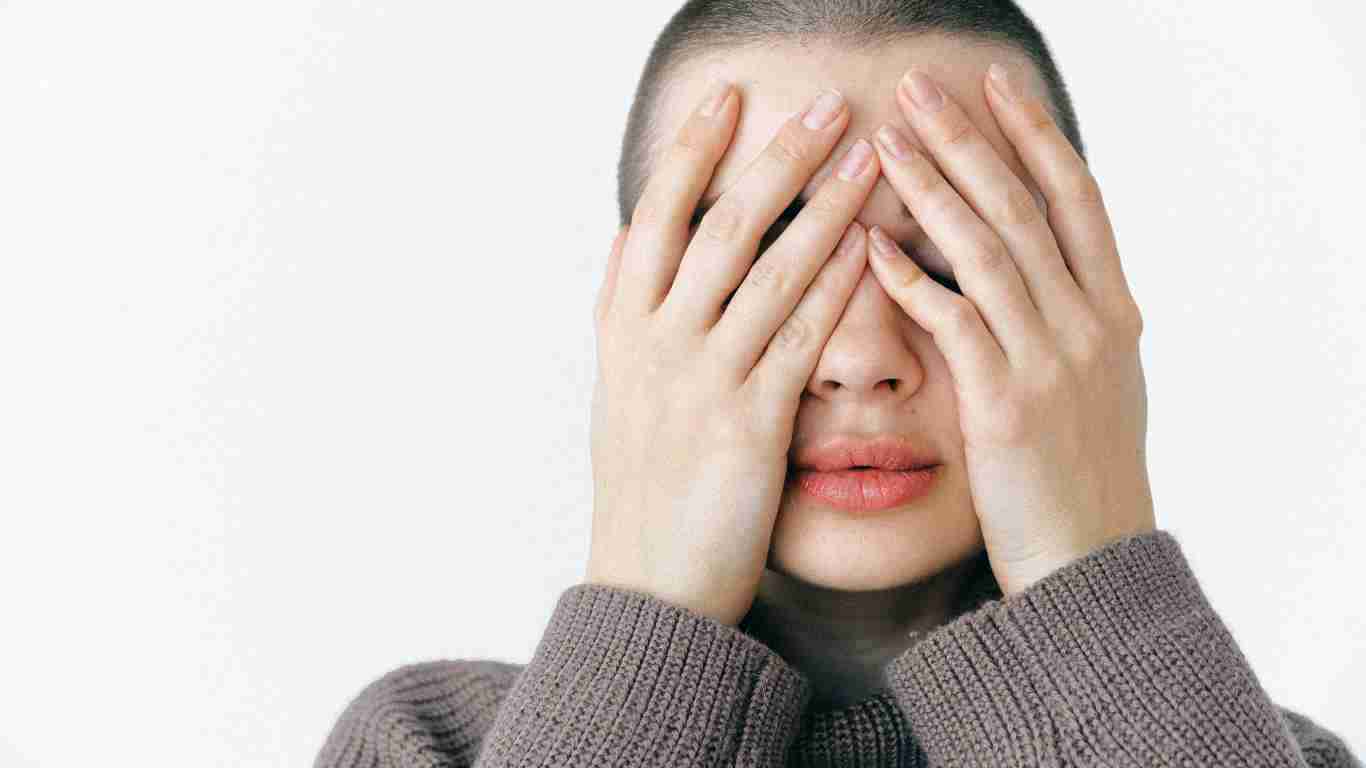 A girl covering her eyes