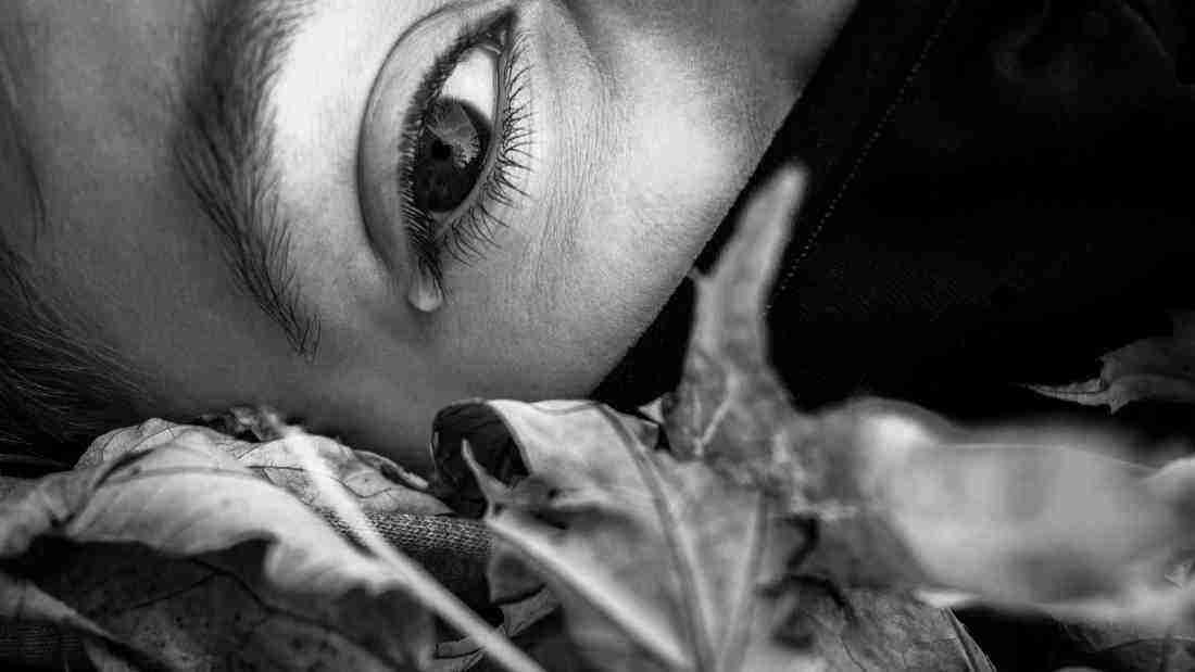 A very unhappy young woman lying on the floor crying