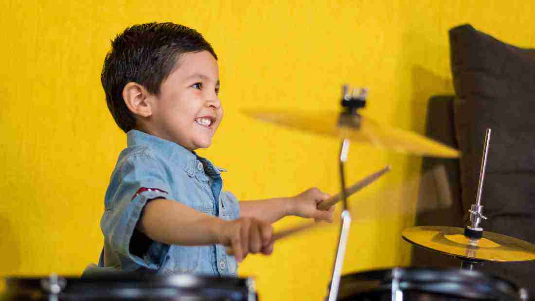 A little boy playing the drums