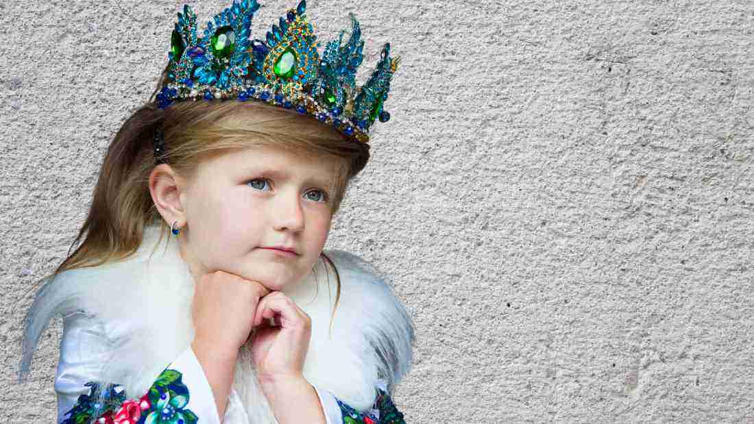 A little girl wearing a crown