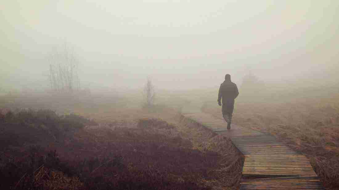 A man running in the fog