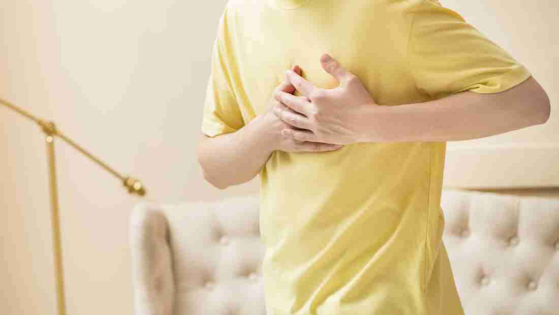 A man clutching his chest in pain