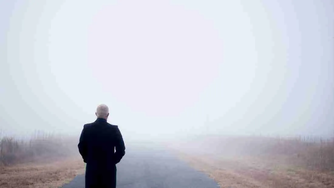 A man standing in a thick fog