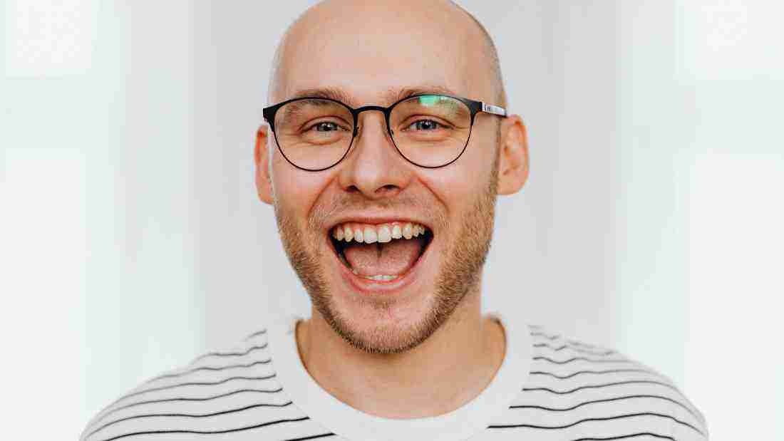 A man guffawing with laughter