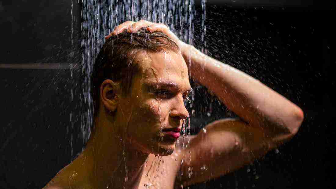 A young man in the shower