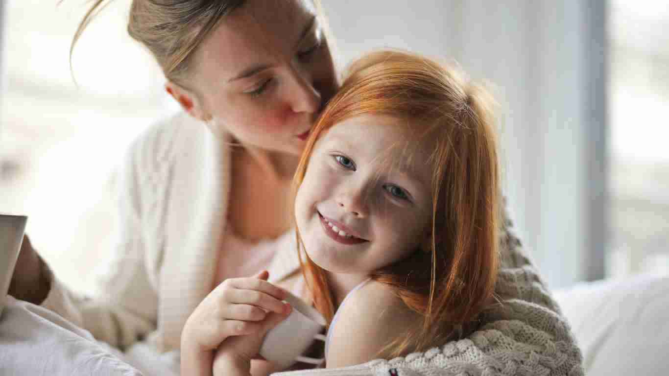 A mother kissing her child