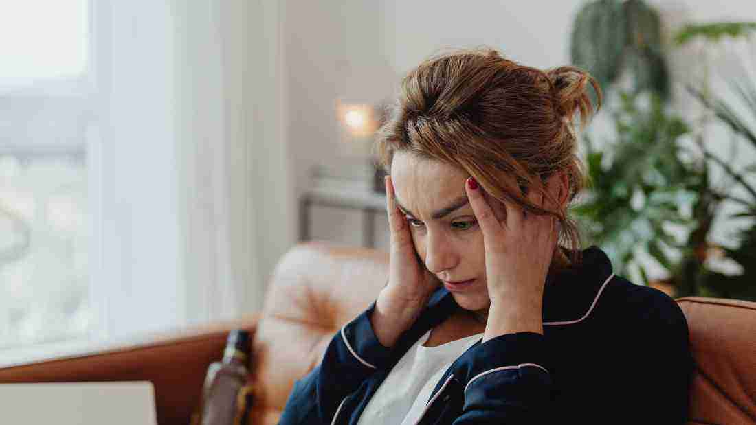 A woman massaging her head because she has a migraine