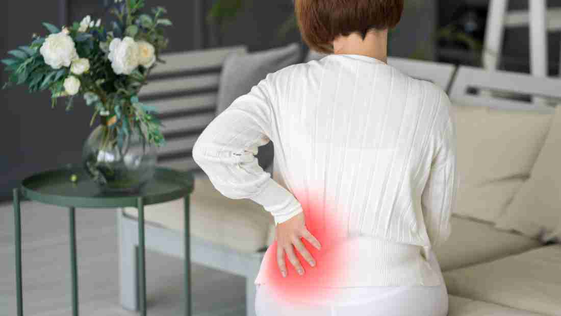 A woman experiencing back pain