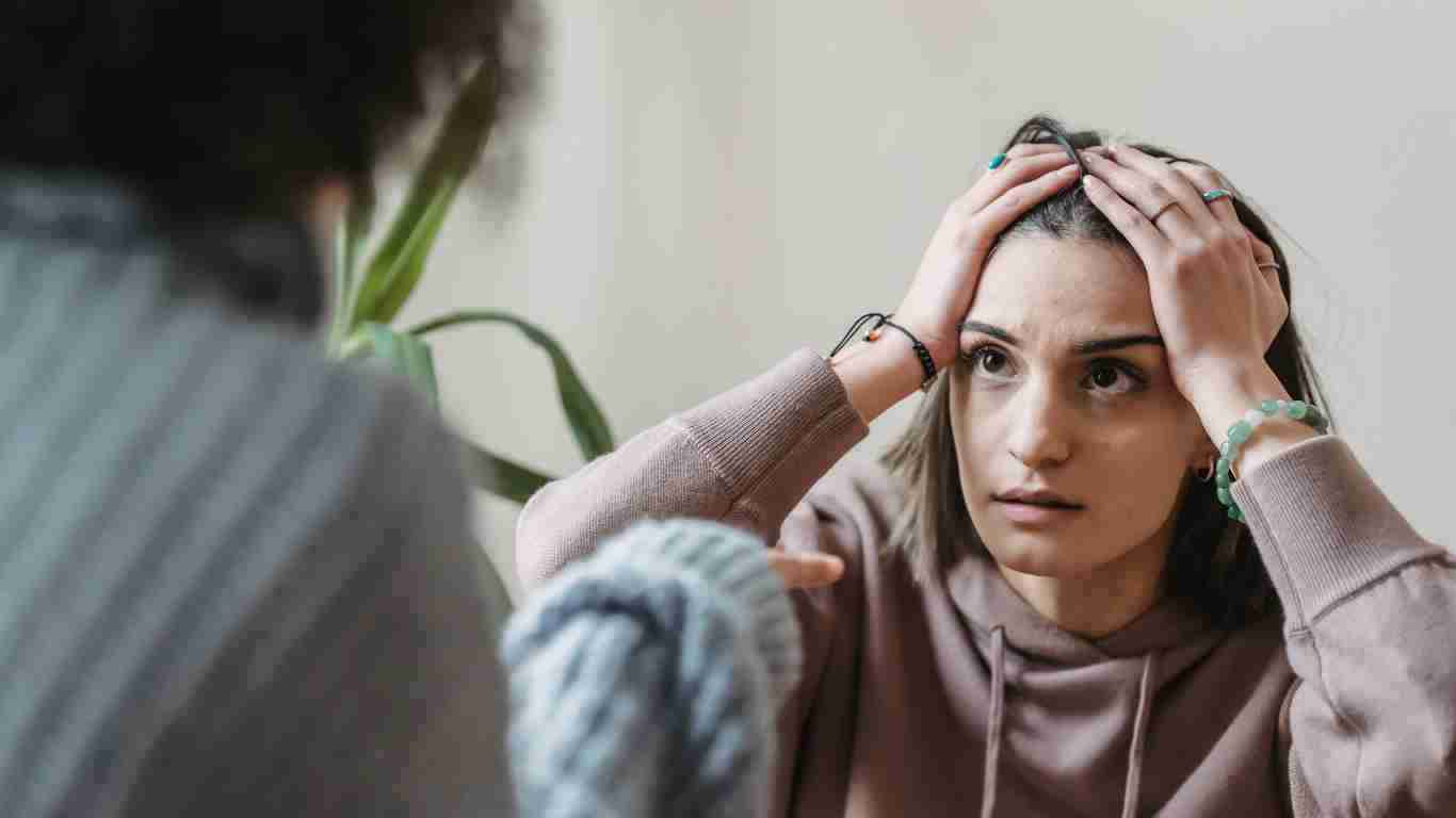 A woman is is overwhelmed with anxiety