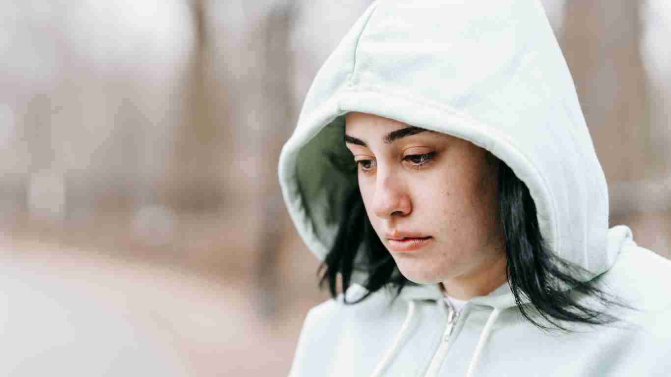 A woman in a hoodie, looking totally overwhelmed