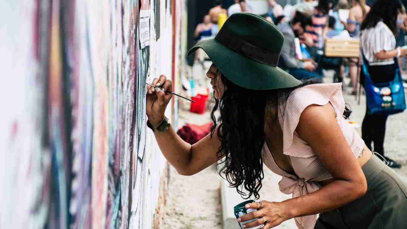 A woman painting a mural