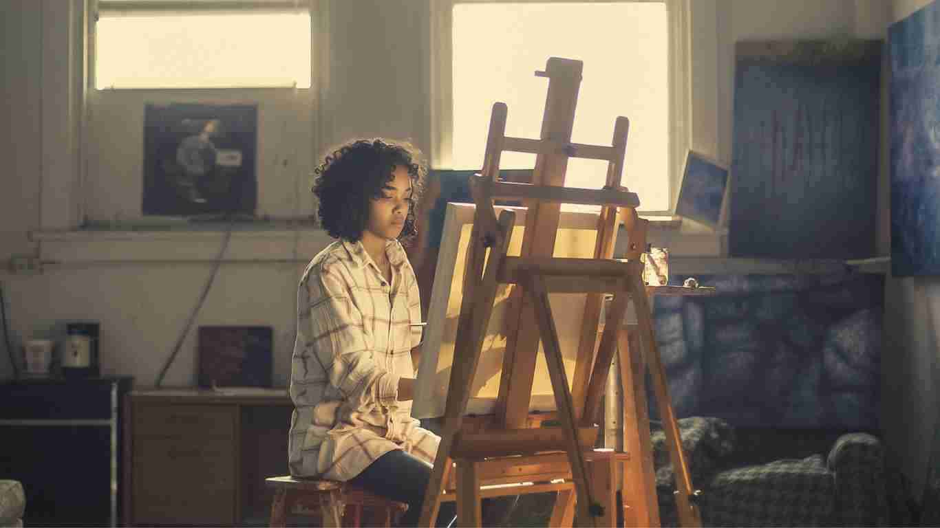 A woman painting on an easel