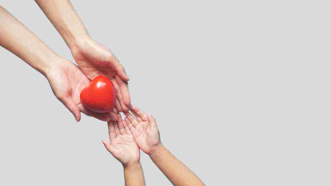 Hands giving a heart to another set of hands