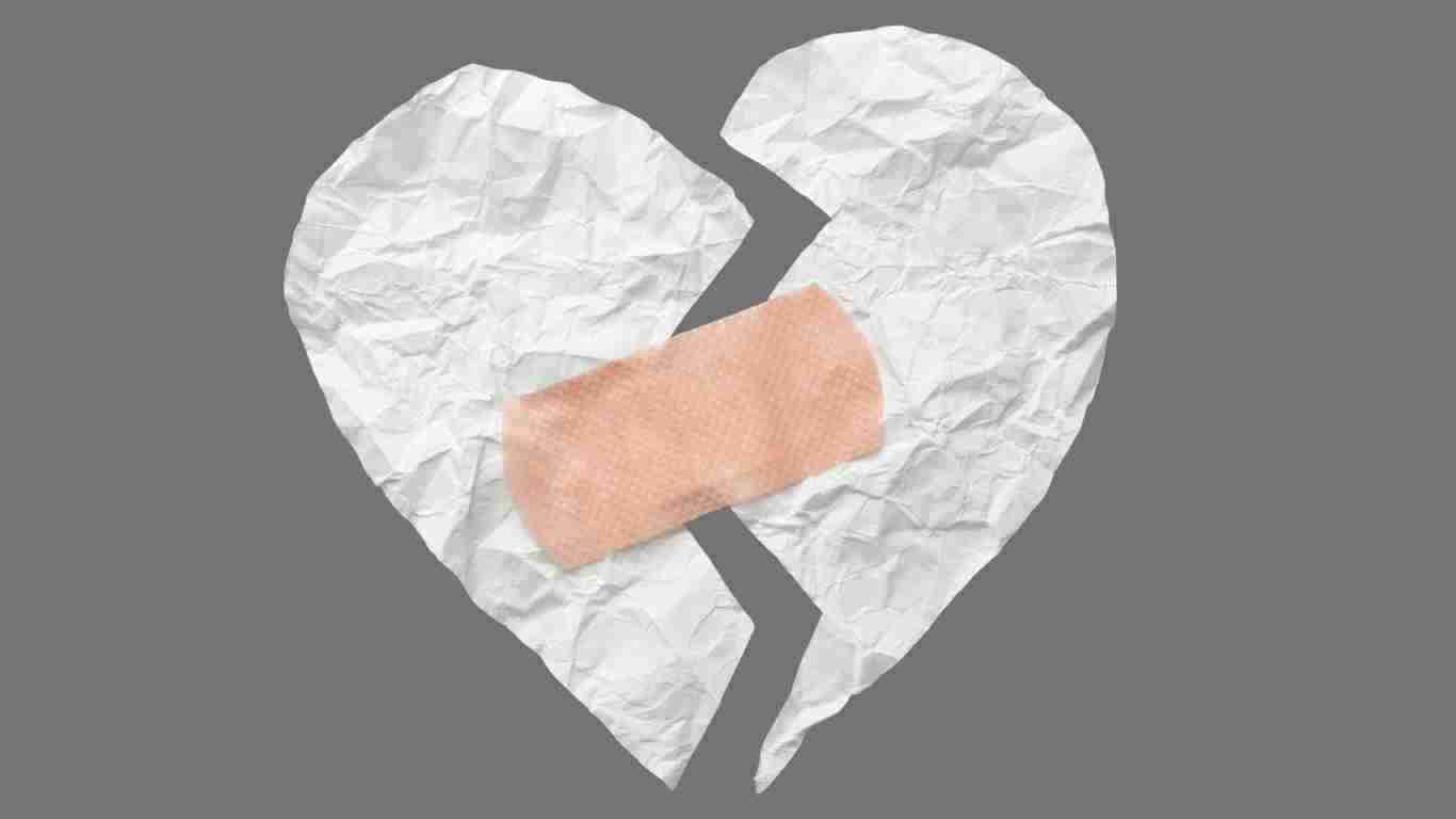 A heart held together by plasters, indicating healing has begun