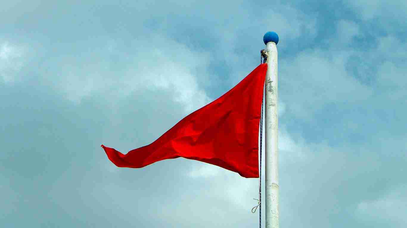 A red flag fluttering in the wind