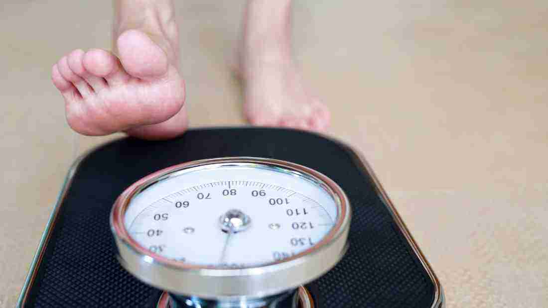 Stepping onto weighing scales