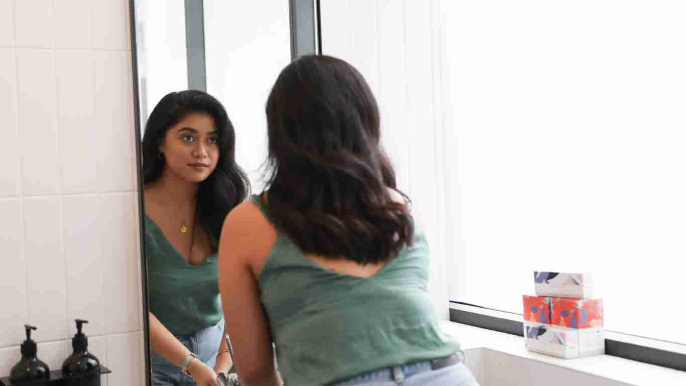 A woman admiring herself in a mirror
