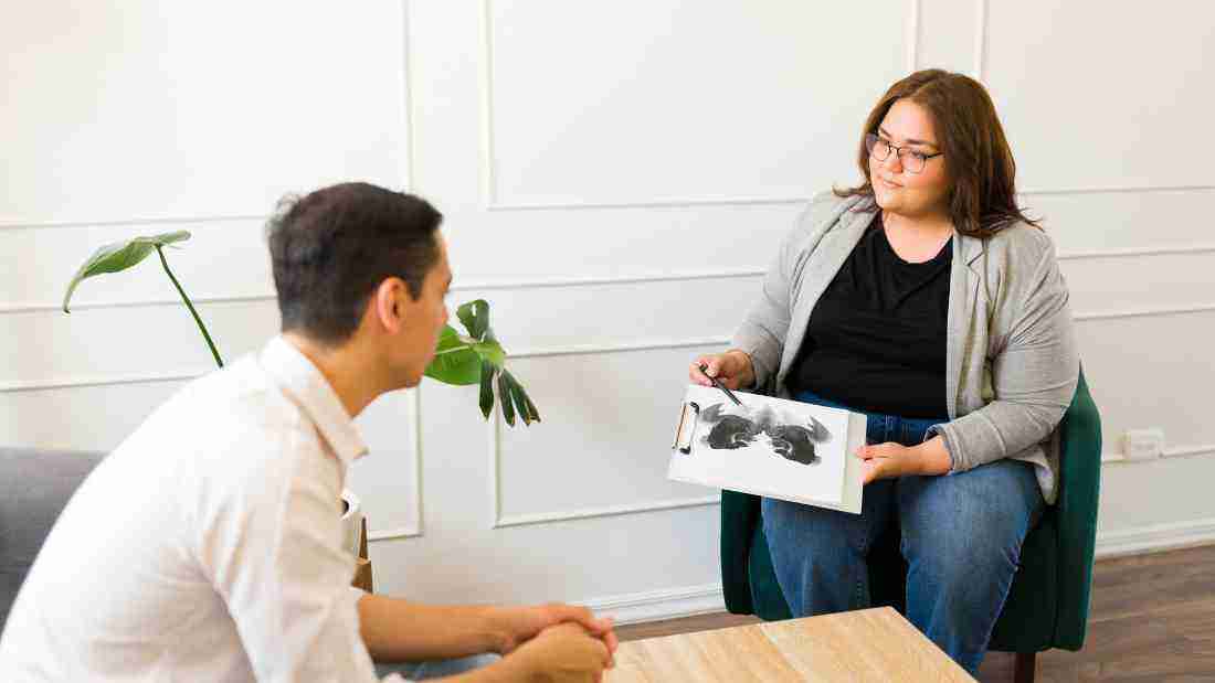 A therapist using the Rorschach ink blot test