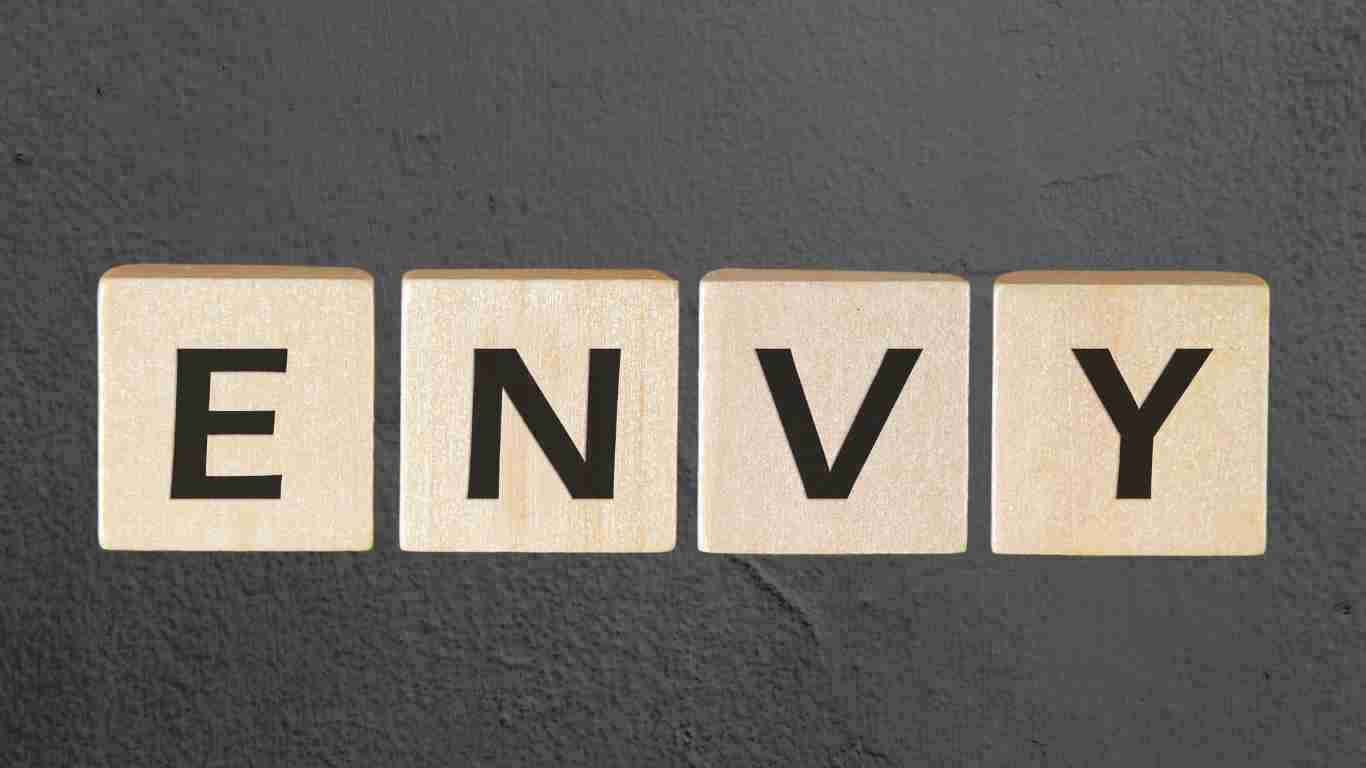 Wooden blocks spelling the word ENVY