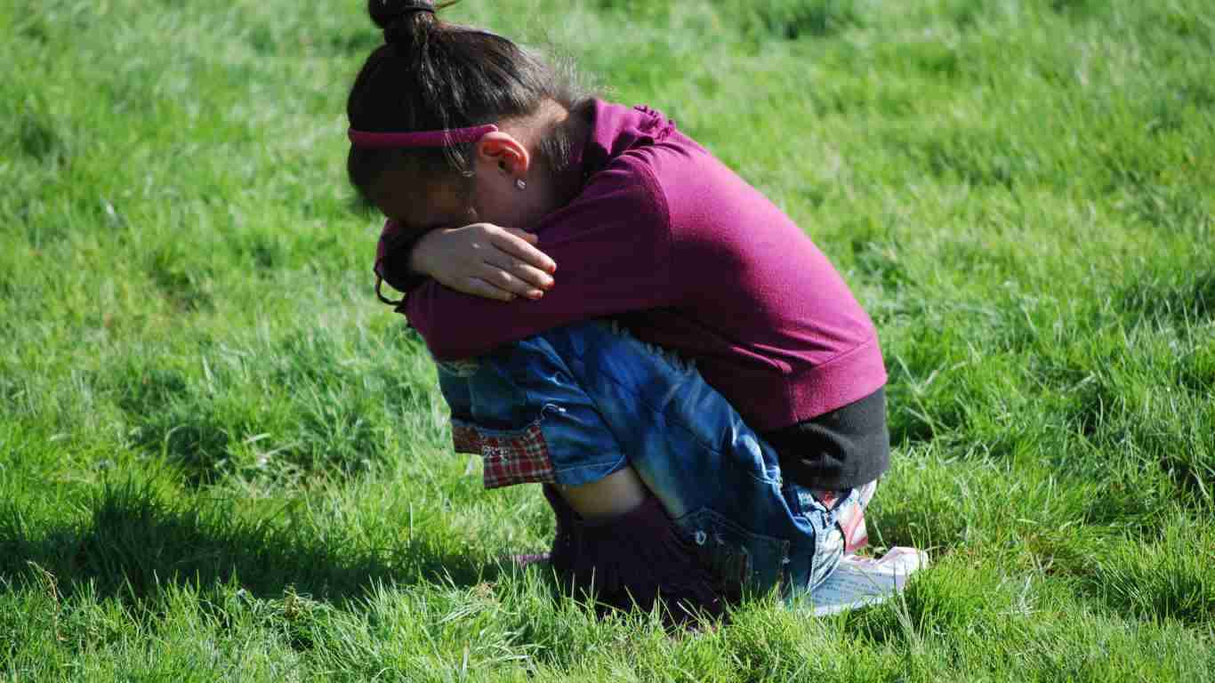A little girl sobbing outside
