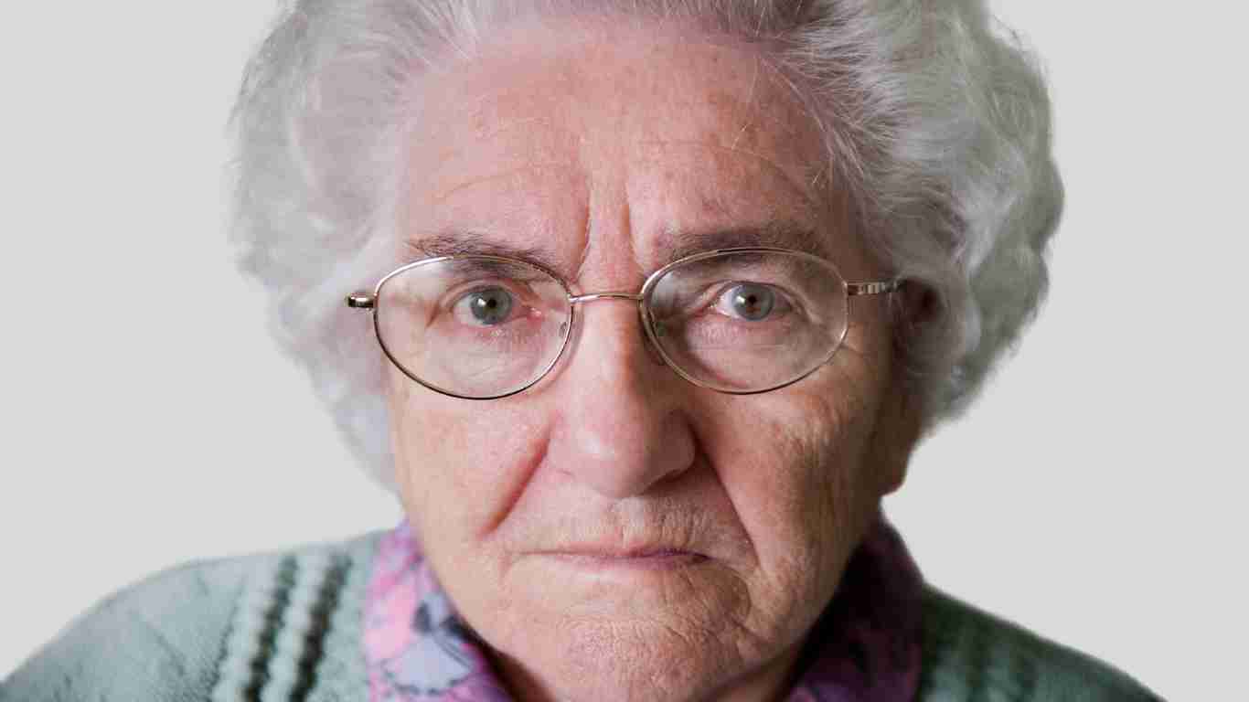 An old narcissistic grandmother scowling at the camera