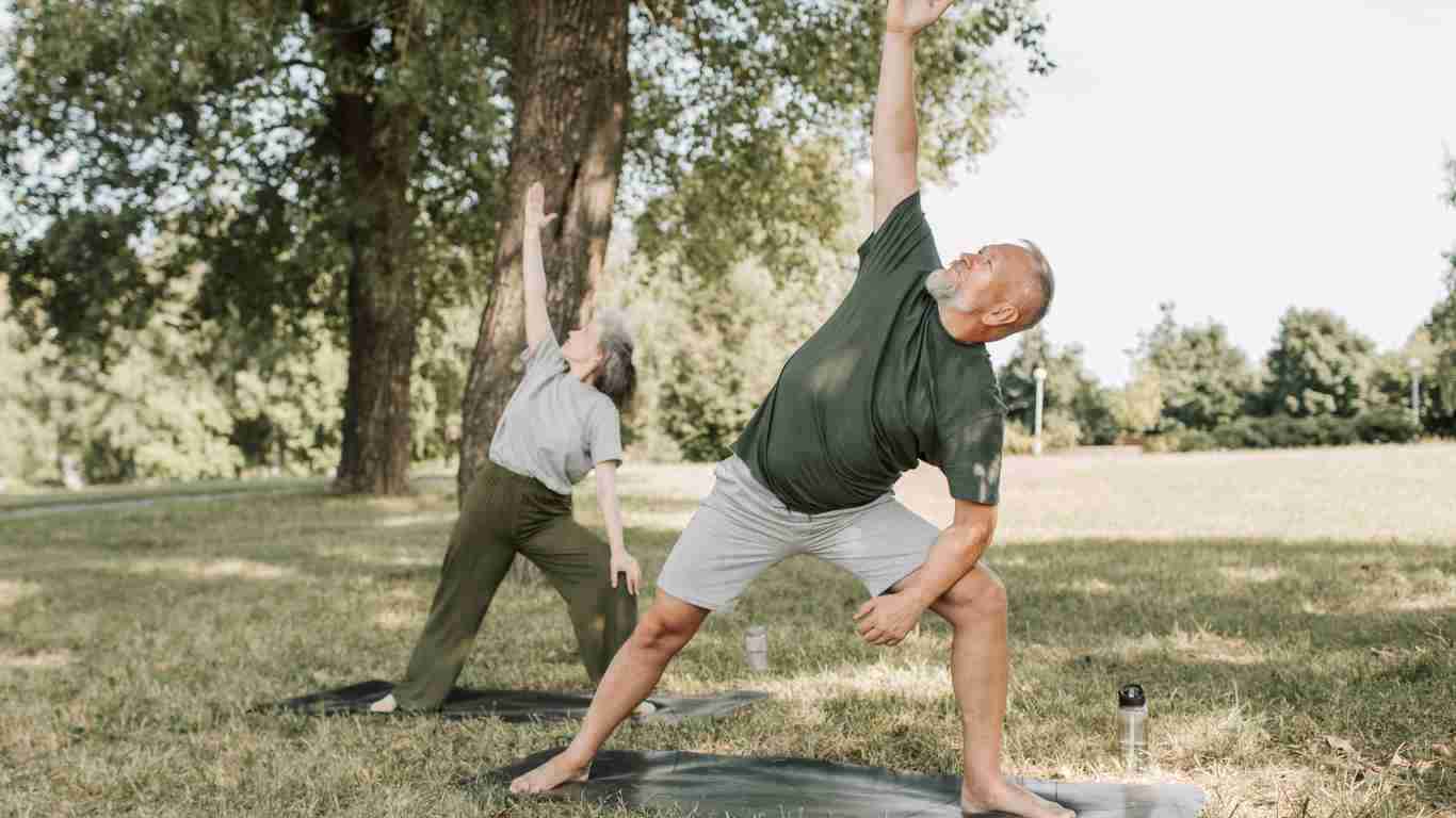An elderly couple doing yoga